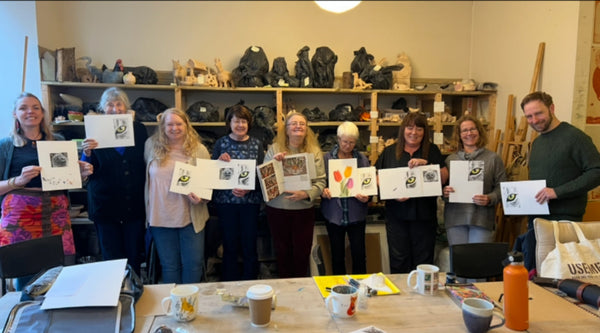 A group of people in Perth Scotland attending a coloured pencil art workshop showing their drawings